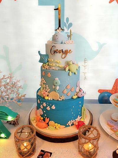 a blue and white cake sitting on top of a table