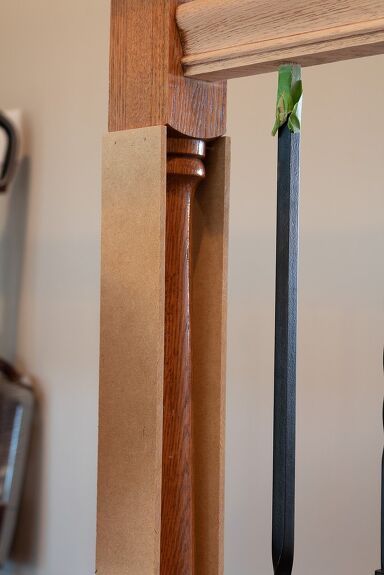 a close up of a clock on a wooden pole