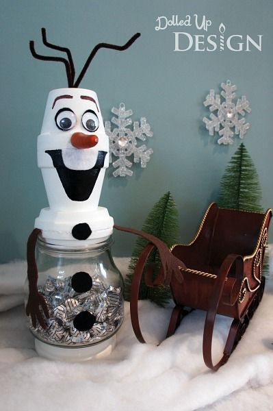 there is a snowman in a jar next to a sleigh