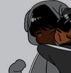 two people hugging each other in front of a gray background