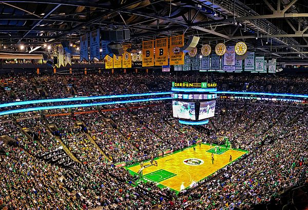 an indoor basketball court with lots of people sitting in the stands and watching it from above