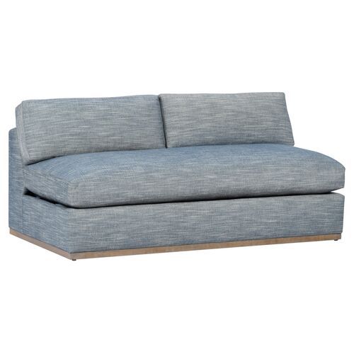 a blue couch sitting on top of a white floor