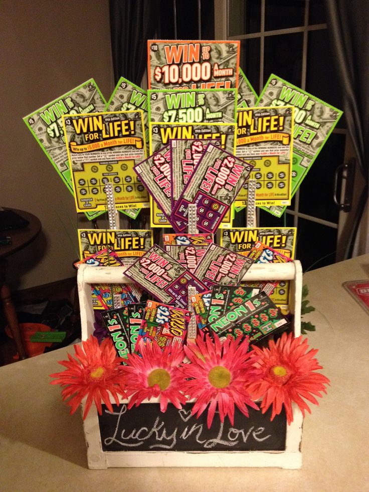 a table topped with a vase filled with flowers and lots of stickers on top of it