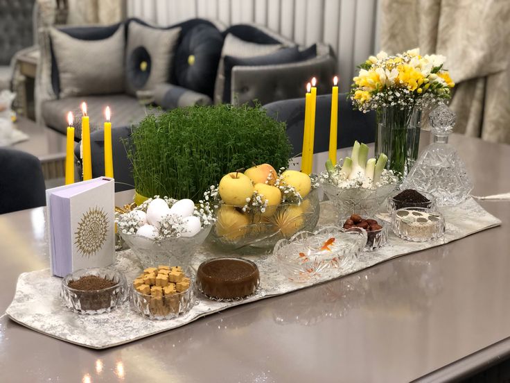 a table topped with lots of desserts and candles