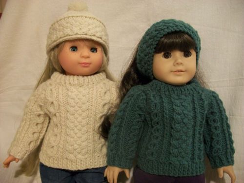 two dolls are standing next to each other