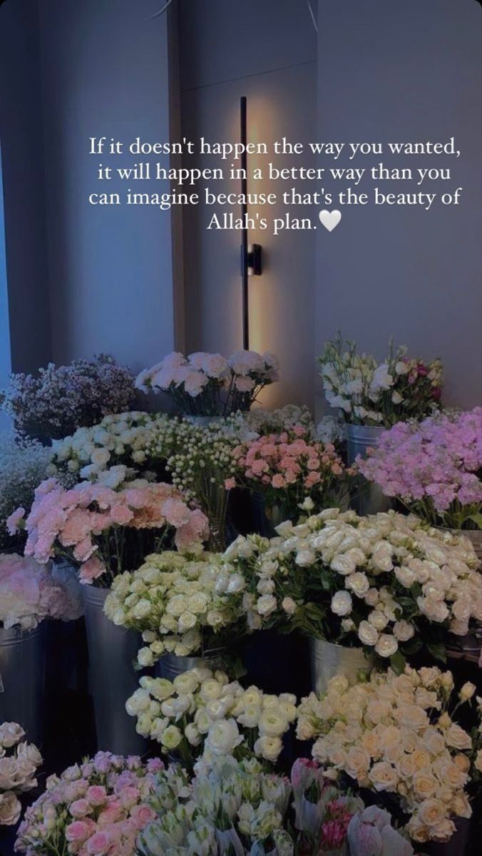 there are many flowers in the vases and one is on the wall with a quote