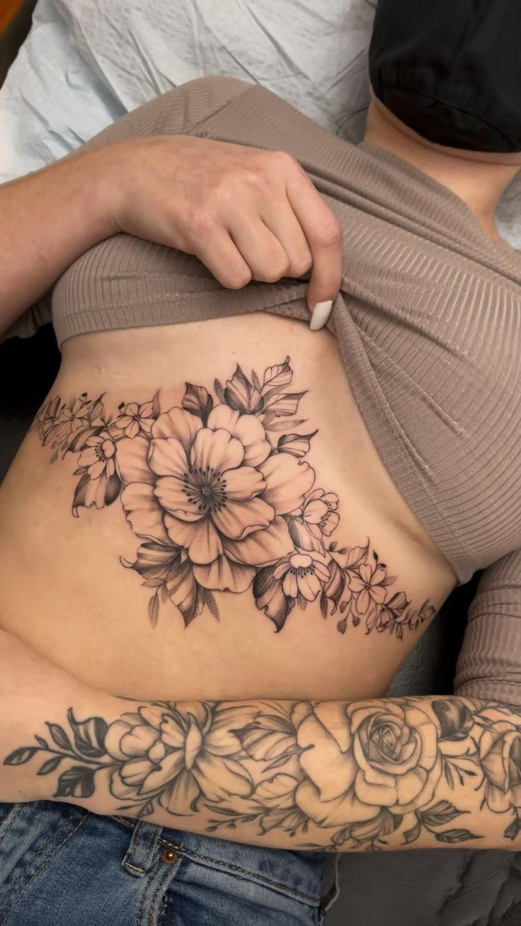 a person with a tattoo on their stomach