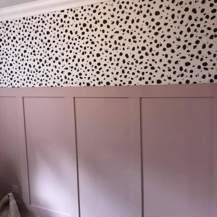 the wall is painted with black and white spots