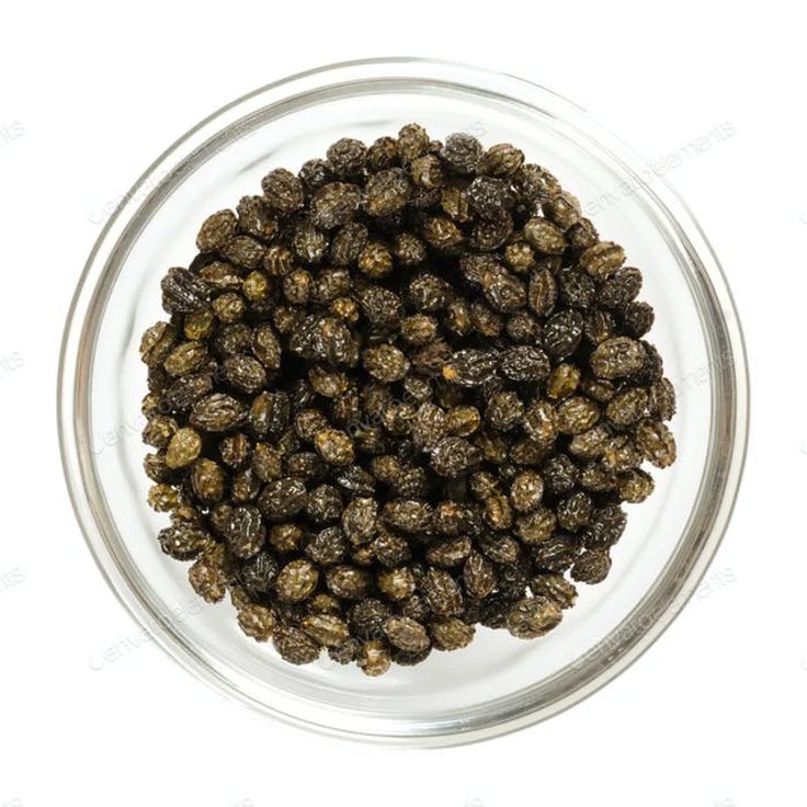 the top view of a glass bowl filled with black pepper on a white background stock photo - images