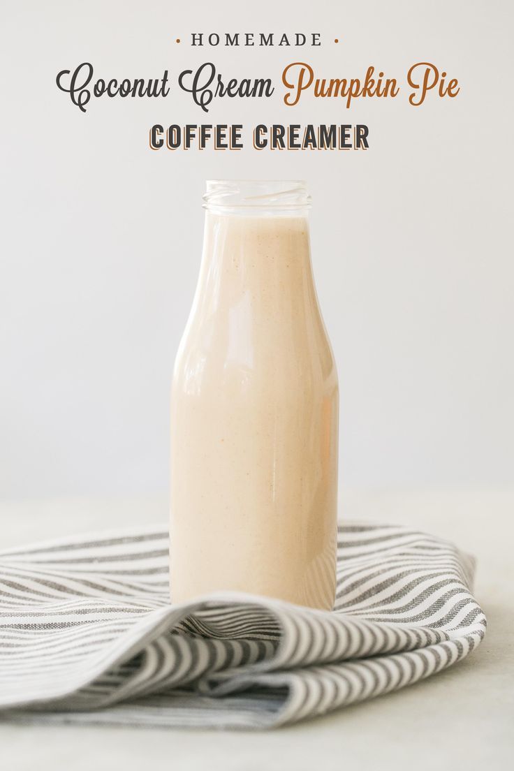 a bottle of coffee creamer sitting on top of a table next to a napkin