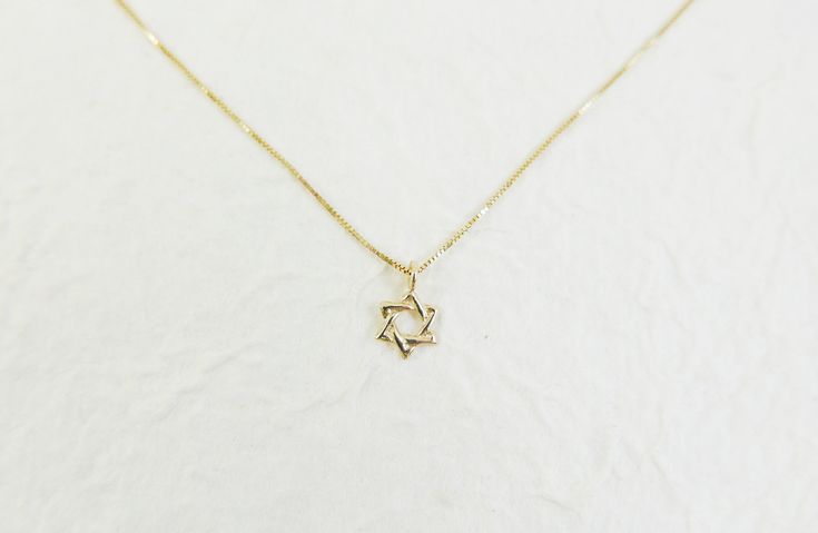 Tiny 14k solid gold star of david necklace. Judaica Jewelry. david star necklace. magen david necklace. kabala necklace. Jewish jewelry This supper tiny Magen David (star of David) is perfect for women or a women who want dainty and tiny pendant. Necklace info : 14kt real solid gold . it can be in yellow or white gold ( select it on the checkout page). The charm wide is 6.6mm High: 10.5 (include hoop) Pendant thickness: 0.67mm. The necklace packaged and shipped in a beautiful gift box. It takes Minimalist 14k Gold Star Of David Necklace, Elegant 14k Gold Star Of David Jewelry, Sterling Silver Star Of David Fine Jewelry Necklace, Dainty Sterling Silver Star Of David Necklace, Star Of David Tarnish Resistant Necklace Gift, Dainty Yellow Gold Star Of David Necklace, Silver Star Of David Necklace In 14k Gold, Gold Star Of David Necklace In 14k Gold, Gold Star Of David Jewelry For Hanukkah