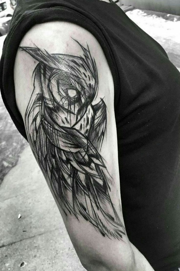 a person with a owl tattoo on their arm