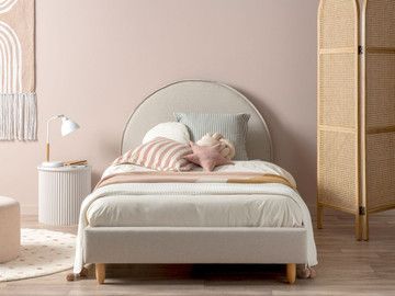 a bedroom with pink walls and white furniture