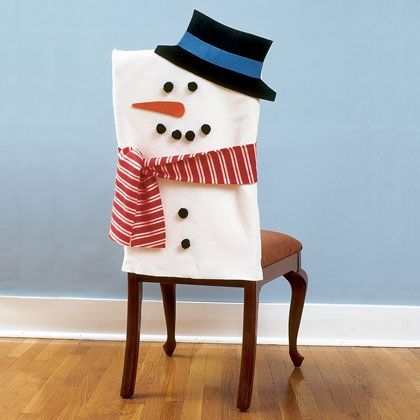 a snowman sitting on top of a wooden chair