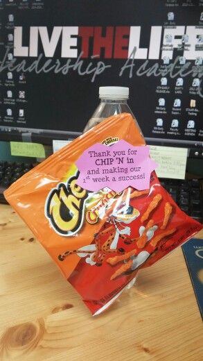 a bag of chips sitting on top of a wooden table next to a computer keyboard