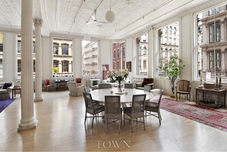 an elegant dining room with white walls and wood floors