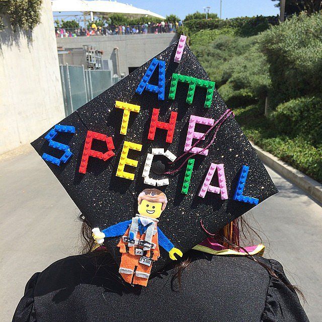 a person wearing a graduation cap with the words at the special written on it and a lego man