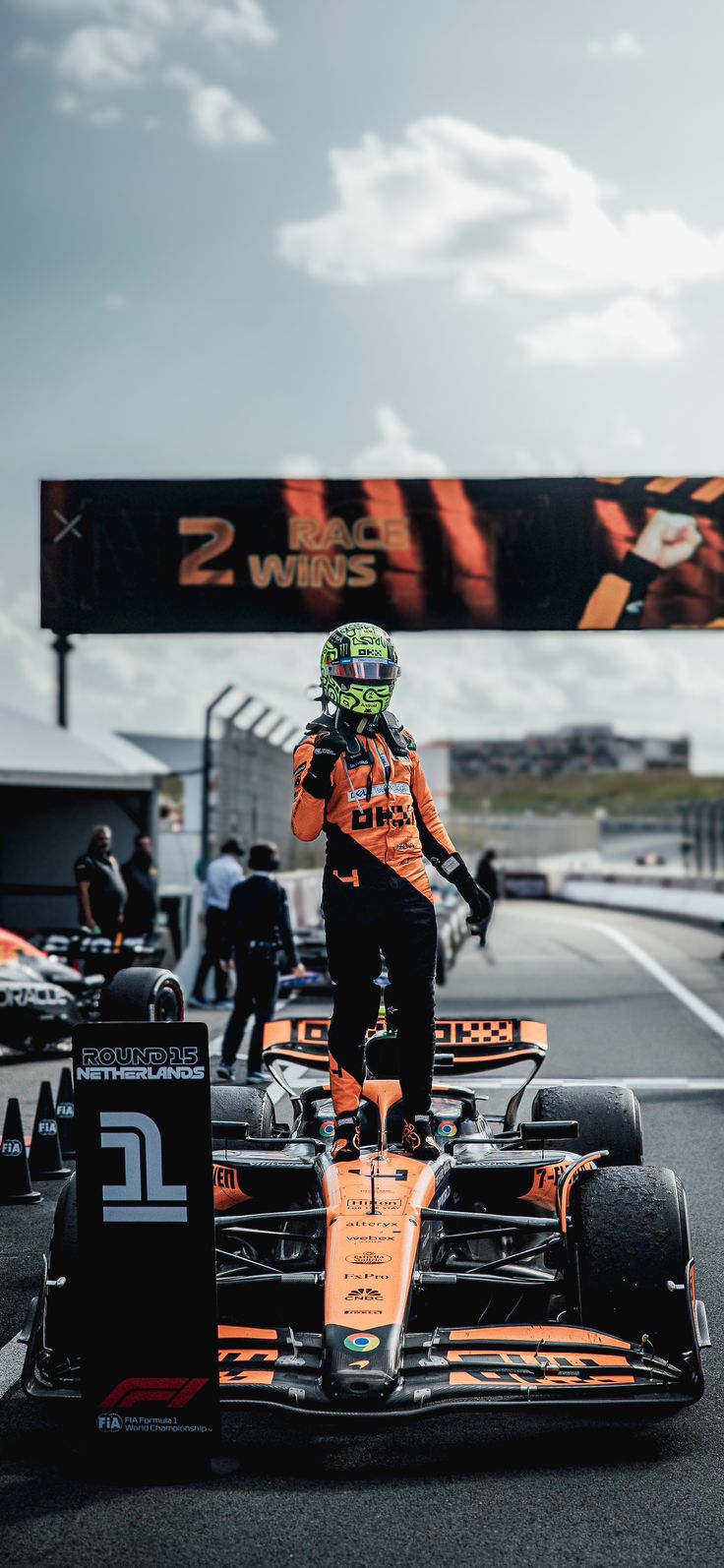 a man standing on top of a race car