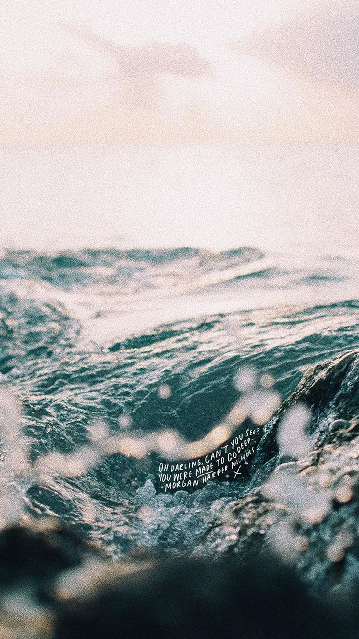 an ocean view with water droplets on it and a quote written in the bottom right corner