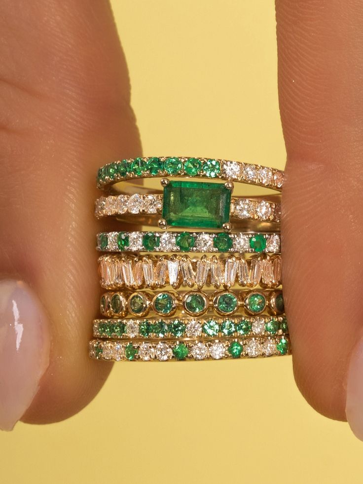 This is your classic diamond band with a BIG pop of color! We are obsessed with this emerald baguette set in the center of the band. You can add this to any ring stack or wear on it's own! Please email hello@shoplemel for different stone color options. Emerald Wedding Band With Diamond Engagement Ring, Emerald Band Rings, Emerald Diamond Band Ring, Emerald Stackable Ring, Emerald Rose Gold Ring, Stackable Wedding Bands For Women, Emerald Wedding Band Stack, Emerald Wedding Ring Stack, Emerald Stacking Ring