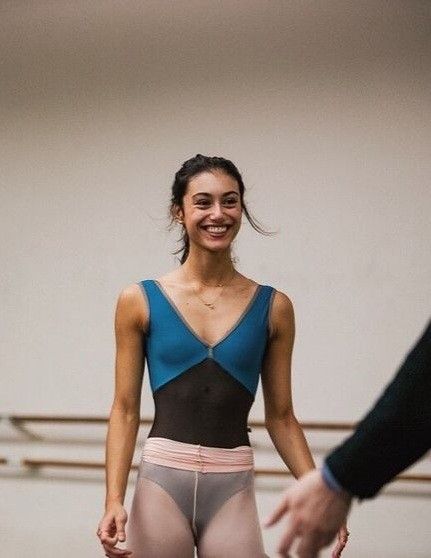 a woman in tights is smiling at someone