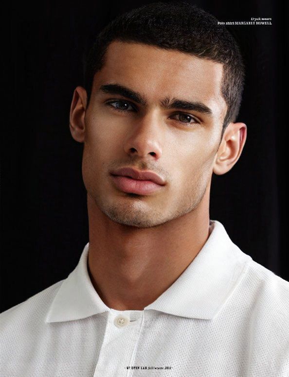 a young man is wearing a white shirt and posing for a magazine cover with his eyes wide open