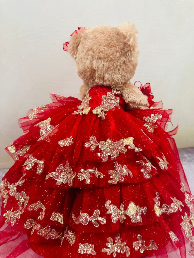 "Add a touch of glamour to your quinceañera celebration with Osito, the custom 23" Teddy bear dressed in a beautiful tulle dress with gold trim. Perfect for a special gift or decoration, Osito is sure to make your celebration even more memorable and unique." Red Tulle Quinceanera Dress For Party, Gold Ball Gown For Quinceanera, Gold Ball Gown Dress For Quinceanera, Elegant Gold Quinceanera Dress, Red Ball Gown Quinceanera Dress For Pageant, Gold Ball Gown For Quinceanera Party, Gold Ball Gown Quinceanera Dress For Party, Gold Tulle Ball Gown For Quinceanera, Gold Princess Dress For Quinceanera