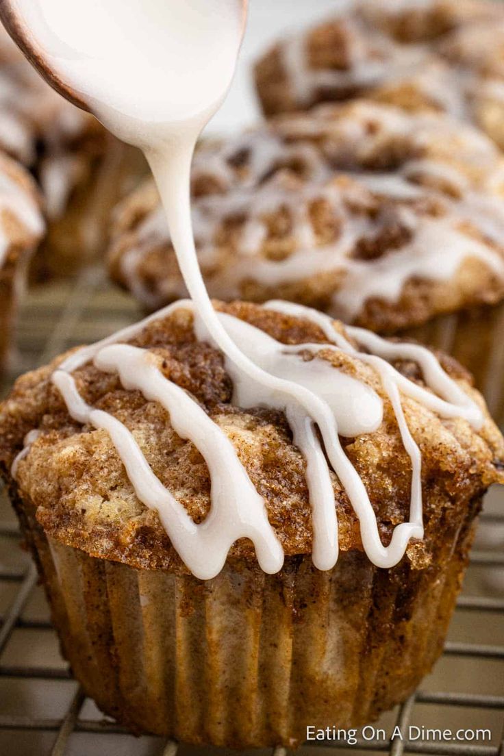 a close up of a muffin being drizzled with icing