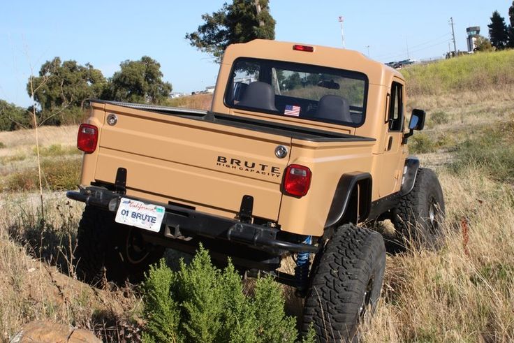 an orange truck is parked in the grass