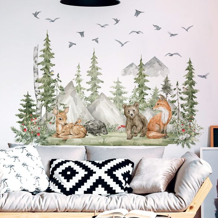 a living room filled with lots of furniture and wallpaper covered in forest animals on it