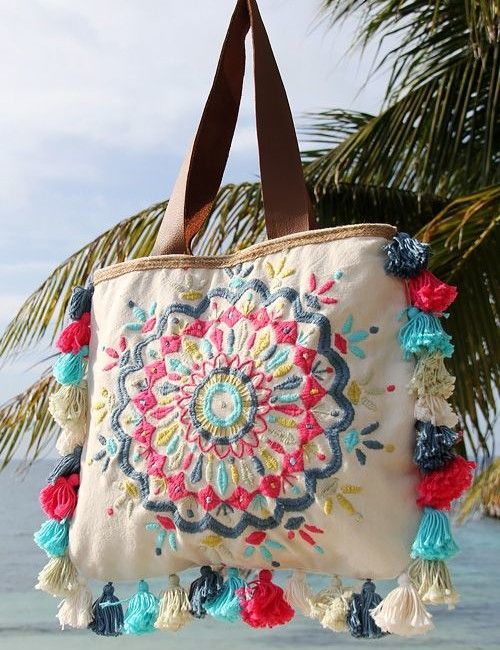 a handbag hanging from a palm tree on the beach