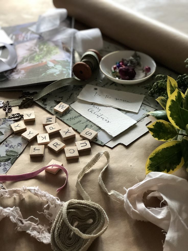 the table is covered with different types of crafting materials and thread spools