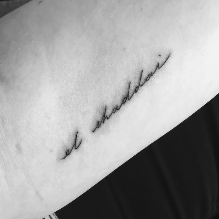 a woman's arm with a tattoo that reads, and the word love is in cursive font