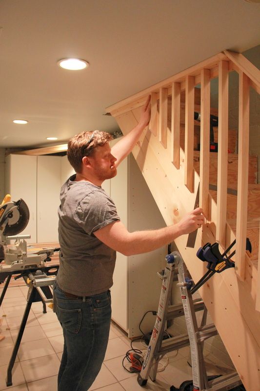 a man is working on some wooden stairs