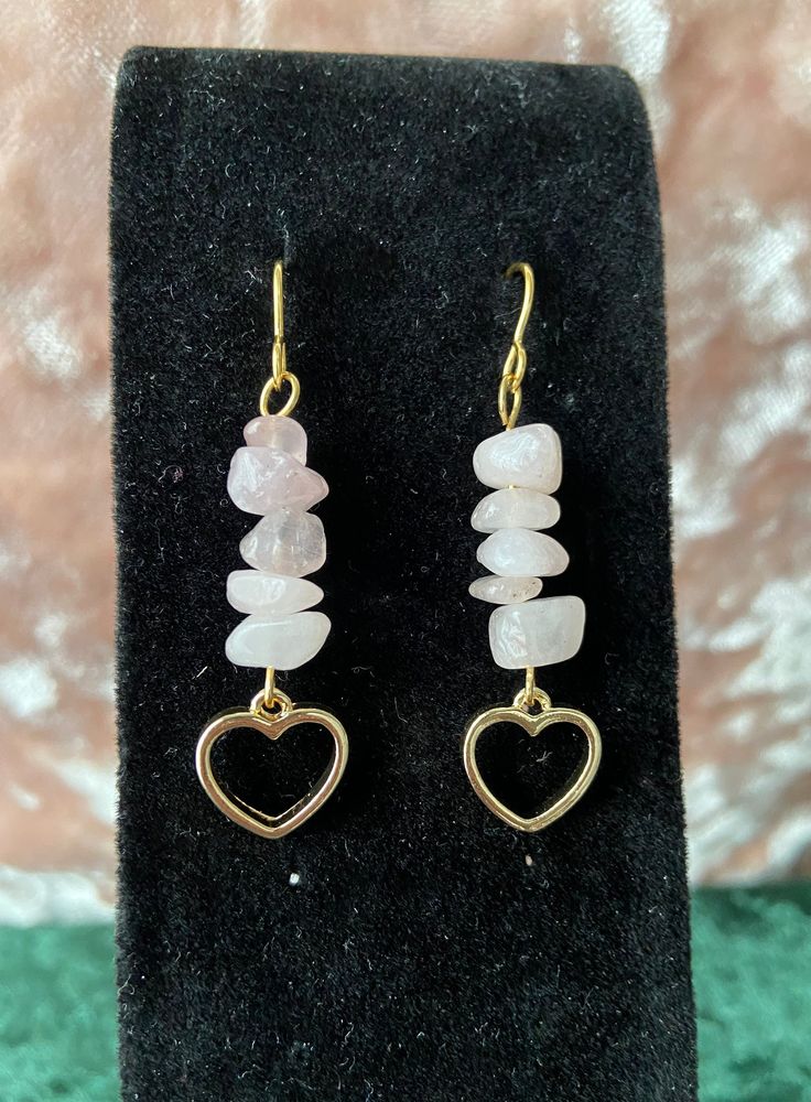 This listing is for one pair of earrings made from rose quartz crystals chips & gold heart charms attached to gold plated french ear wires. Rose quartz is a favorite crystal of the shop owner's, as it is a crystal representative of love. Rose quartz promotes healing & harmony, and is a great stone to help with maintaining loving relationships with oneself & others. Note: The appearance of the earrings, color, & exact measurements may vary, due to natural variations in the crystals. Simple Wire Bead Earrings, Crystal Stone Earrings, Quartz Earrings Diy, Halloween Crystal Jewelry, Small Handmade Earrings, Chip Bead Earrings, Crystal Chip Earrings, Gold Rose Quartz Earrings For Gift, Gemstone Chip Earrings