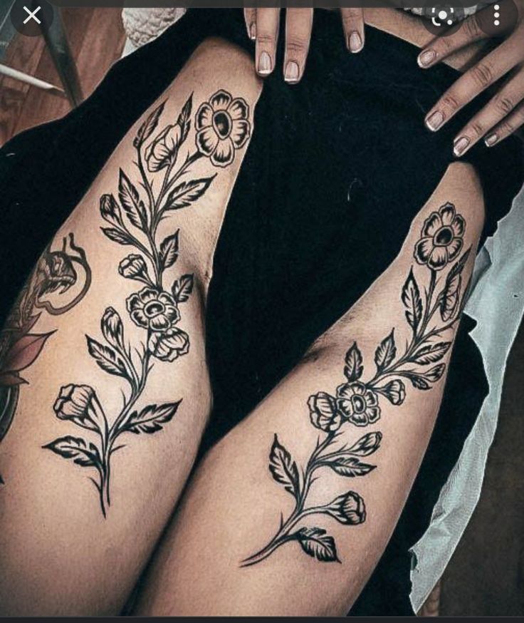 a woman's legs with tattoos on them