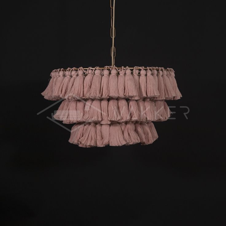 a pink chandelier hanging from a black ceiling with fringes on the bottom