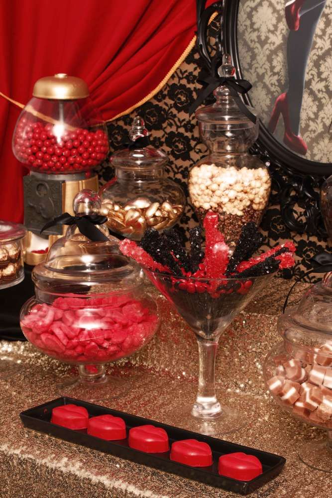 an assortment of candy and candies on a table with a mirror in the background