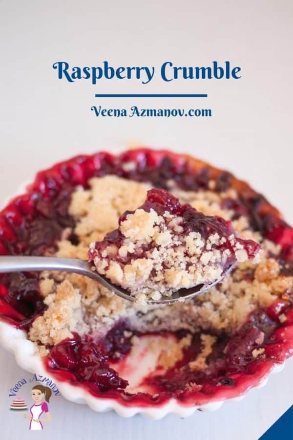 a bowl filled with raspberry crumble on top of a white table