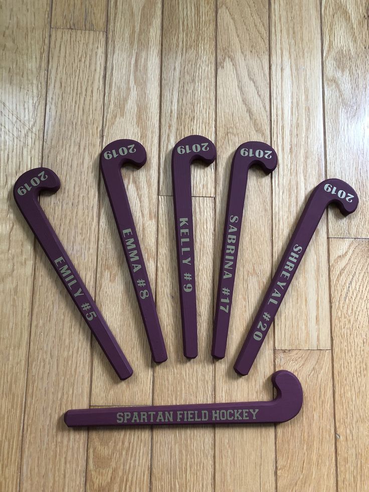 five purple wrenches with the words sparta field hockey on them sitting on a wooden floor