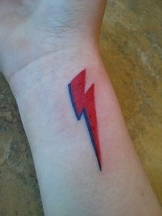 a small red and blue lightning bolt tattoo on the left inner wrist is shown in an instagram