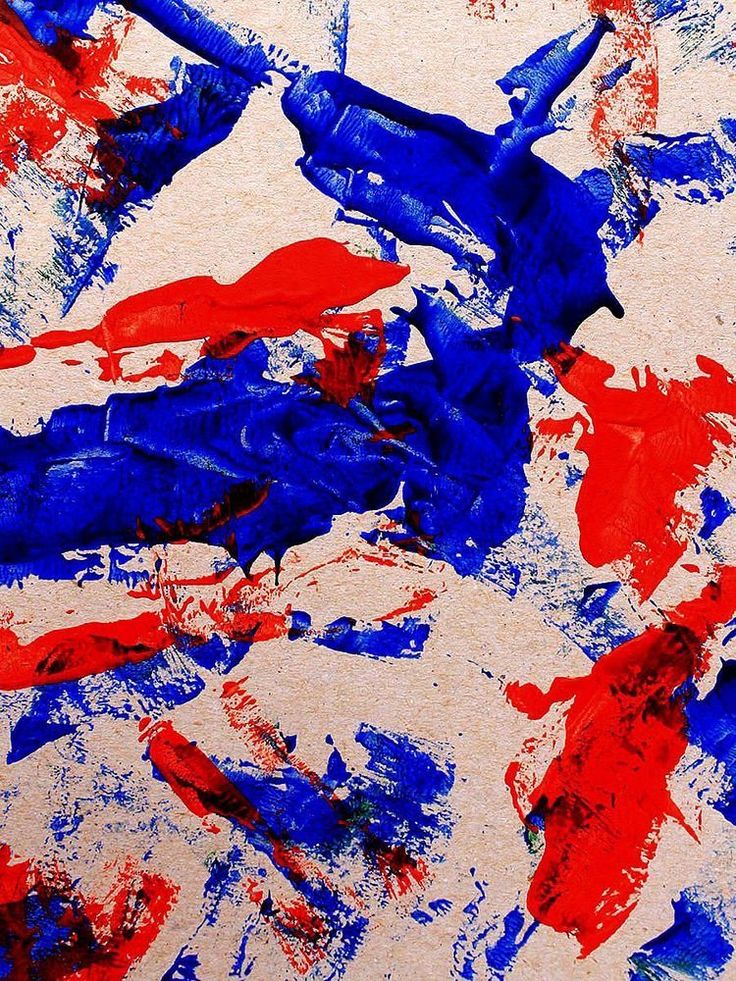 red, white and blue paint splattered on the surface of a piece of paper