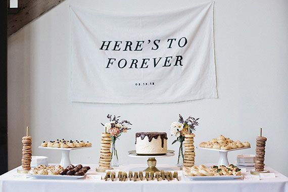 there's to forever sign hanging over a table with desserts and pastries