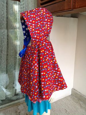 a mannequin wearing a red dress with blue and white polka dots on it