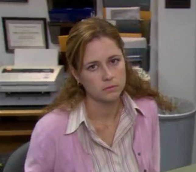 a woman sitting in an office chair looking at the camera while staring into the distance