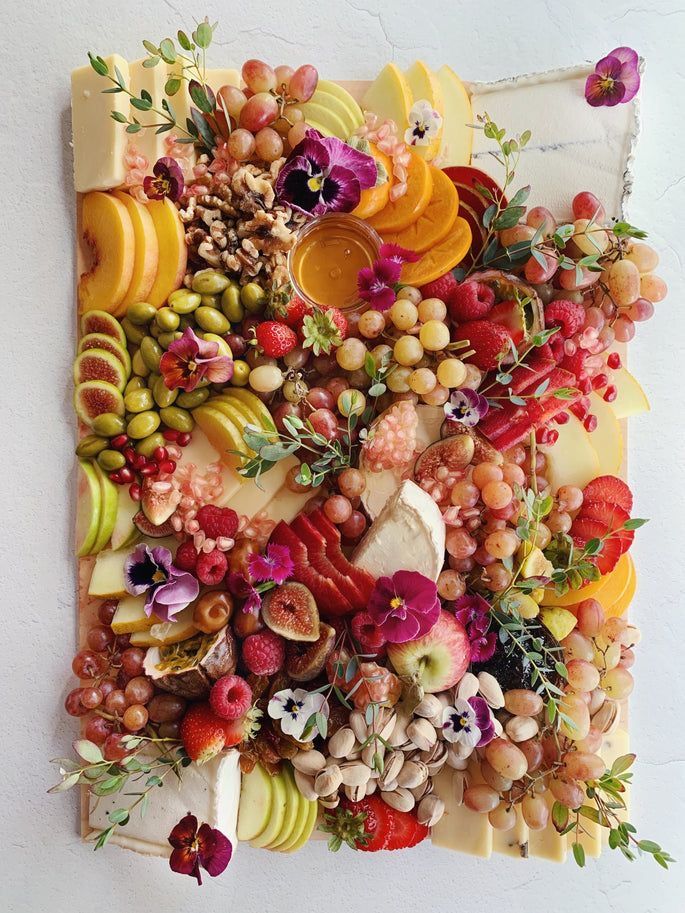 an arrangement of fruits and vegetables on a piece of paper