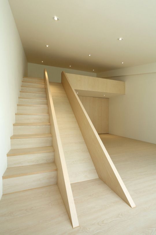 an empty room with stairs leading up to the second floor