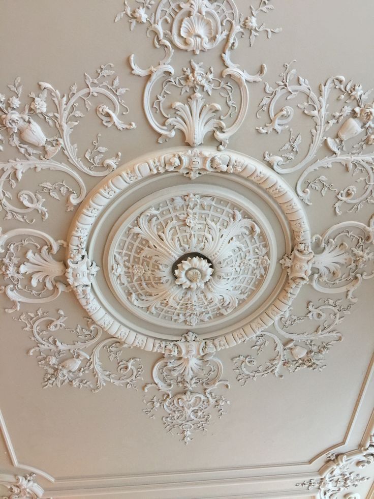 an ornate ceiling with white paint on it