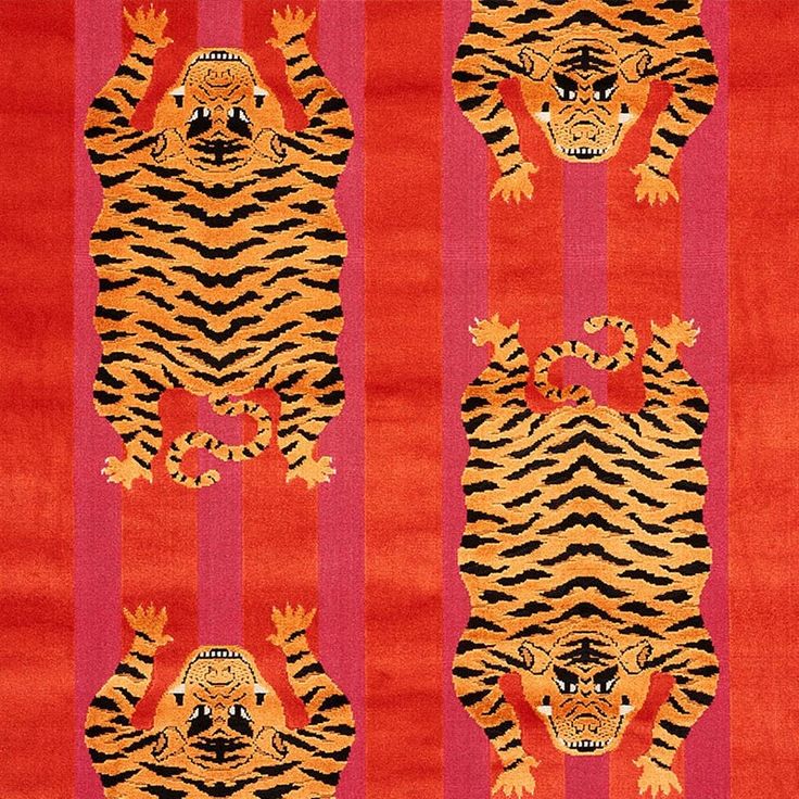 an orange and red rug with tigers on it