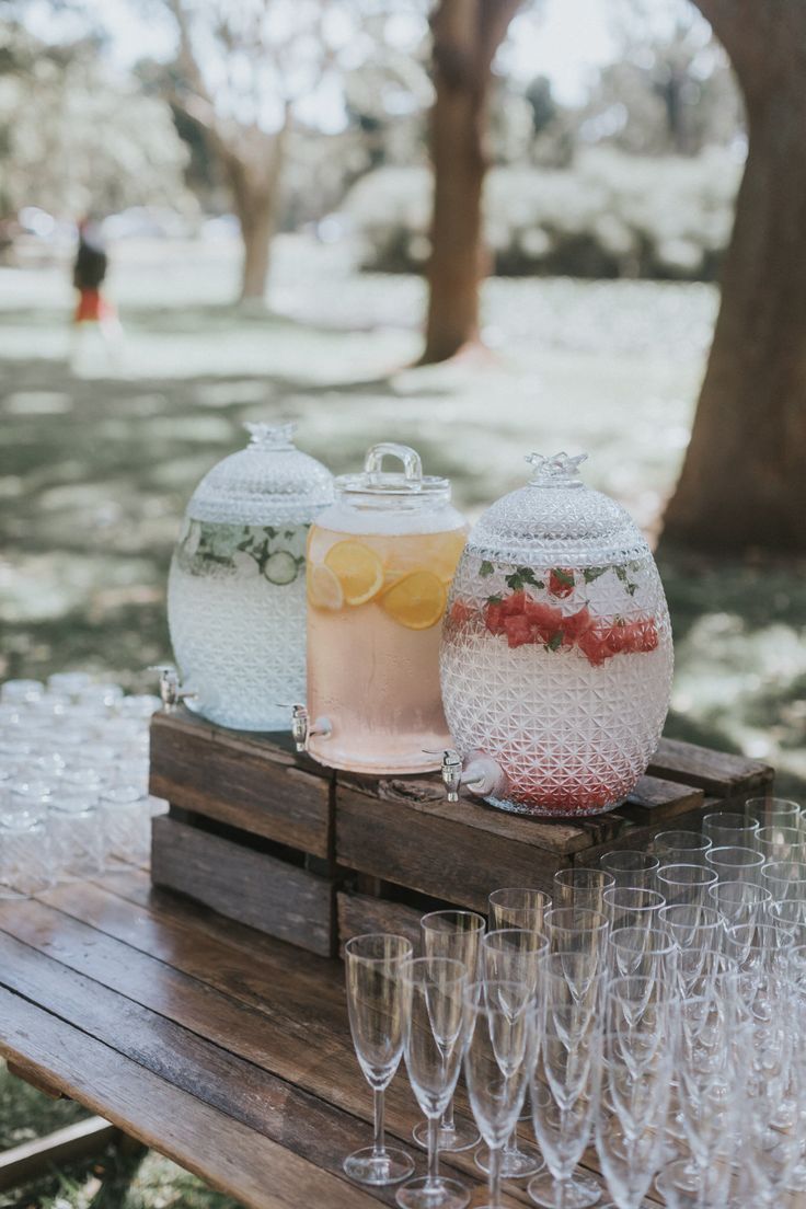 wine glasses are lined up on a picnic table